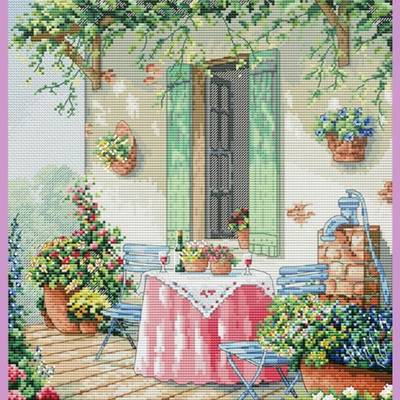 фото: картина, вышитая крестиком, столик на улице возле открытого окна, цветы
